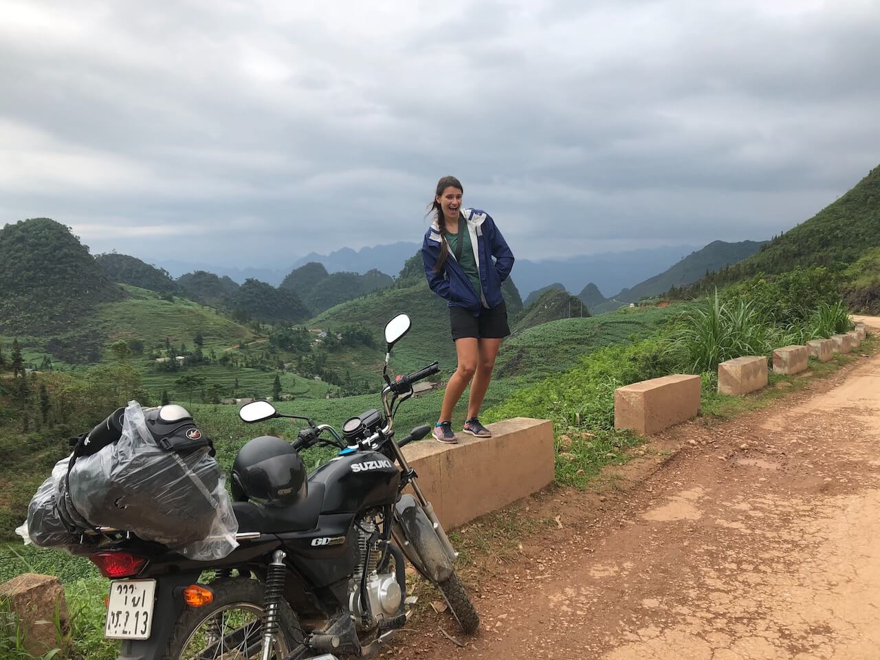 nicola standing beside a motorbike on the ha giang motorbike loop vietnam